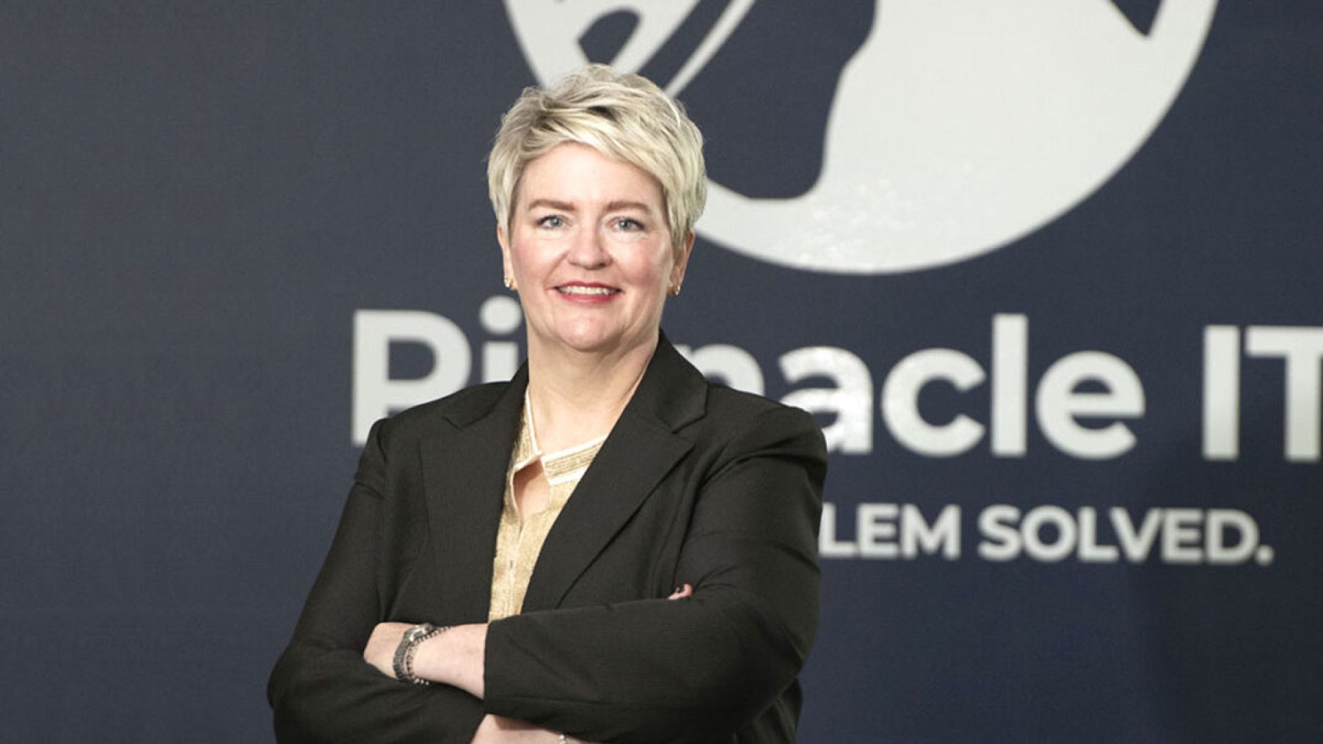 Teri Westbrook in front of Pinnacle IT logo backdrop